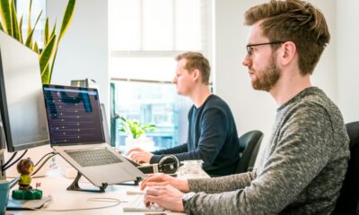 young professionals working laptops office