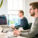 young professionals working laptops office
