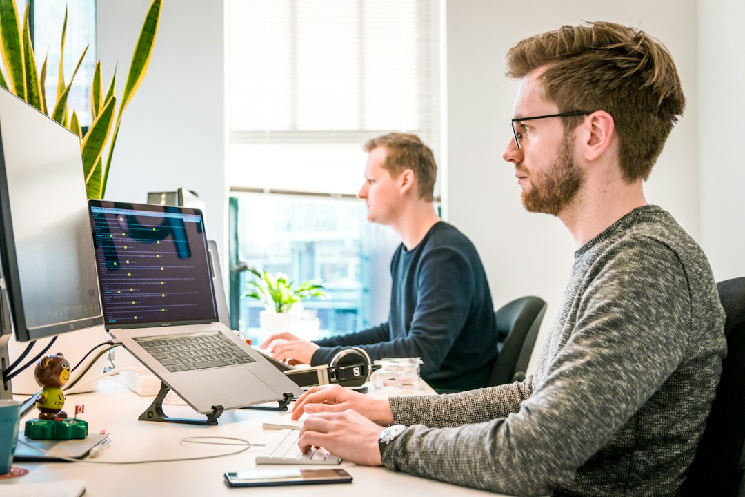 young professionals working laptops office